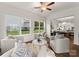 Bright sun room featuring a ceiling fan, comfortable seating, and neighborhood views at 6034 Jepson Ct, Charlotte, NC 28214