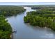 Scenic view of a calm lake surrounded by lush greenery, showcasing the waterfront property at 6034 Jepson Ct, Charlotte, NC 28214