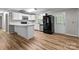 Open kitchen with island and black appliances at 4972 Mayble St, Catawba, NC 28609