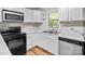 White kitchen cabinets and black appliances at 4972 Mayble St, Catawba, NC 28609