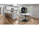 Modern kitchen with white cabinets, breakfast bar, and a black fridge at 4972 Mayble St, Catawba, NC 28609