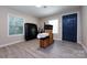 Spacious bedroom with wood-look floors and a dark blue door at 1762 Old Carter St, Lancaster, SC 29720