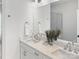 Bright bathroom with double vanity, quartz countertops, and large mirror reflecting the glass shower at 459 Blairhill Rd # 02, Charlotte, NC 28217