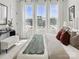 Sunlit bedroom featuring a large bed, modern decor, and large windows with scenic views at 459 Blairhill Rd # 02, Charlotte, NC 28217