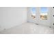 An empty bedroom with two large windows at 459 Blairhill Rd # 02, Charlotte, NC 28217