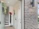 Inviting entryway featuring a gray brick exterior and a view of the modern staircase and stylish decor at 459 Blairhill Rd # 02, Charlotte, NC 28217