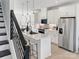 Modern kitchen features a center island with bar seating, stainless steel appliances, and flows into the living area at 459 Blairhill Rd # 02, Charlotte, NC 28217