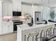 Modern kitchen with white cabinetry, stainless steel appliances, an island with a quartz countertop, and bar stool seating at 459 Blairhill Rd # 02, Charlotte, NC 28217