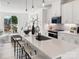 Spacious kitchen with an island, quartz countertops, stainless appliances, white cabinets, and an open view to the living area at 459 Blairhill Rd # 02, Charlotte, NC 28217