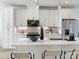 Bright kitchen featuring white cabinets, stainless steel appliances, and a center island with stylish bar stool seating at 459 Blairhill Rd # 02, Charlotte, NC 28217