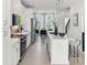 Open-concept kitchen and dining area with white cabinets, stainless steel appliances, and an island with bar seating at 459 Blairhill Rd # 02, Charlotte, NC 28217