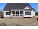 Covered back porch with white railings and brick base on a gray house with large windows at 1228 Sage Pine Cir # 12, Clover, SC 29710