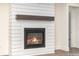 Close-up of a modern fireplace with a shiplap surround and a wooden mantel at 1228 Sage Pine Cir # 12, Clover, SC 29710