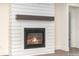 Modern shiplap fireplace with dark mantel and gas logs for a cozy ambiance at 1228 Sage Pine Cir # 12, Clover, SC 29710