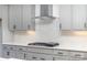 Kitchen with gray cabinets, gas cooktop and white backsplash at 1228 Sage Pine Cir # 12, Clover, SC 29710
