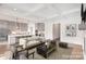 Open-concept living room showcasing a modern kitchen, coffered ceilings, and hardwood floors at 1228 Sage Pine Cir, Clover, SC 29710