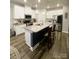 Modern kitchen featuring white cabinets, a large island, and stainless steel appliances at 3524 Tully Ave, Kannapolis, NC 28081