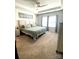 Bright main bedroom with a decorative ceiling, neutral walls, large windows, and plush carpeting at 3524 Tully Ave, Kannapolis, NC 28081