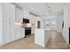 Bright kitchen with white cabinets, large island, and modern lighting, creating an ideal space for cooking and entertaining at 455 Blairhill Rd # 03, Charlotte, NC 28217