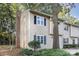 Tan two-story townhome with brick chimney and landscaping at 3178 Heathstead Pl, Charlotte, NC 28210