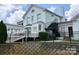 Large white brick home with a deck and a black metal staircase at 3178 Heathstead Pl, Charlotte, NC 28210