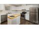 Galley kitchen with white cabinets and stainless steel appliances at 3178 Heathstead Pl, Charlotte, NC 28210