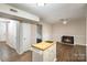 Kitchen with island and view into living room with fireplace at 3178 Heathstead Pl, Charlotte, NC 28210