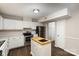 Kitchen with white cabinets, stainless steel appliances, and kitchen island at 3178 Heathstead Pl, Charlotte, NC 28210