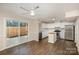 Eat-in kitchen with white cabinets, stainless steel appliances, and wood flooring at 3178 Heathstead Pl, Charlotte, NC 28210