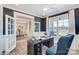 Bright home office features built-in shelving and French doors at 3245 Mcharney Dr # 28, Harrisburg, NC 28075