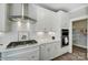 Bright kitchen with white cabinets, hexagonal backsplash, and gas cooktop at 3245 Mcharney Dr # 28, Harrisburg, NC 28075