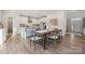 Bright dining room with hardwood floors and farmhouse table at 117 Brooke Forest Ct, Mooresville, NC 28115