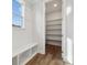 White built-in pantry with shelving and hardwood floors at 117 Brooke Forest Ct, Mooresville, NC 28115