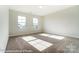 Bright bedroom with carpet flooring and two large windows at 3221 Mcharney Dr # 31, Harrisburg, NC 28075