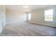 Spacious bedroom with neutral carpeting and two large windows at 3221 Mcharney Dr # 31, Harrisburg, NC 28075