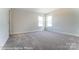 Spacious bedroom with wall-to-wall carpet and two windows at 3221 Mcharney Dr # 31, Harrisburg, NC 28075