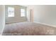 Well-lit bedroom with neutral carpeting and ample space at 3221 Mcharney Dr # 31, Harrisburg, NC 28075