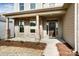 Brick front porch with a dark brown front door at 3221 Mcharney Dr # 31, Harrisburg, NC 28075