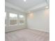 Bright bedroom with neutral carpeting and large windows at 10511 Boudreaux St, Huntersville, NC 28078