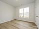 Bright bedroom with large window and light brown vinyl flooring at 10511 Boudreaux St, Huntersville, NC 28078