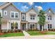 Three-unit townhome building, gray siding, green doors, landscaping at 10511 Boudreaux St, Huntersville, NC 28078