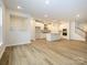 Open kitchen with island, white cabinets, and stainless steel appliances at 10511 Boudreaux St, Huntersville, NC 28078