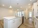 Modern kitchen with white cabinets, island, and stainless steel appliances at 10511 Boudreaux St, Huntersville, NC 28078