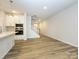 Open concept kitchen features white cabinets and a view into the living room at 10511 Boudreaux St, Huntersville, NC 28078