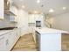 Modern kitchen with white cabinets, large island, and stainless steel appliances at 10511 Boudreaux St, Huntersville, NC 28078