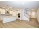 Bright kitchen boasts white cabinets, stainless steel appliances, and an island at 10511 Boudreaux St, Huntersville, NC 28078