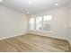 Light-filled living room featuring hardwood floors and neutral walls at 10511 Boudreaux St, Huntersville, NC 28078