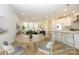 Open floor plan featuring a kitchen island and dining area seamlessly flowing into the living room at 10511 Boudreaux St, Huntersville, NC 28078