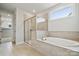 Serene bathroom showcasing a soaking tub, glass-enclosed shower, and neutral tile work at 124 Kepli Way, Mooresville, NC 28115