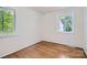 Bright bedroom featuring hardwood floors and two windows offering natural light at 3245 Minnesota Rd, Charlotte, NC 28208